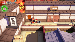 Mario standing near a lamp post containing a Coin in Shogun Studios of The Origami King.