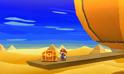 Mario near a treasure chest containing the Tablet Piece scrap in Yoshi Sphinx of Paper Mario: Sticker Star.