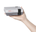 Hand holding NES Classic Edition as scale.