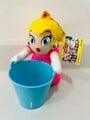 A plushie of Peach with a bucket from Mario & Wario