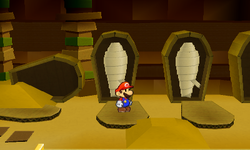 Mario near two opened coffins containing Shiny POW Block Sticker each in Sandshifter Ruins of Paper Mario: Sticker Star.
