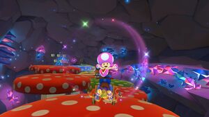 Toadette tricking off the red mushrooms in the cave of Wii Mushroom Gorge.