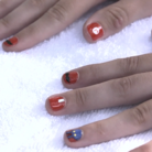 Still from a video showcasing a Mario-inspired manicure session with American actress Olivia Holt