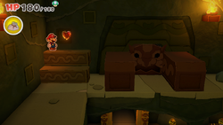 Mario standing near a Healing Heart in Sea Tower of The Origami King.