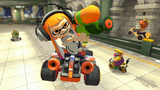 Inkling Girl performing a trick. Toadette, Bowser, Wario, and Baby Daisy can be seen driving in the background in Super Bell Subway.