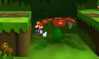 Mario stands on the side of a jungle flower as if its leaves are not currently collapsed.