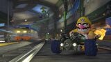 Wario driving through the tunnel section of the track.