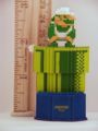 Pixelated figurine of Luigi crouching on a Warp Pipe