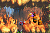 Quawks picks up a barrel to the right of a red Buzz and a green Buzz in Buzzer Barrage in the Game Boy Advance remake