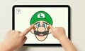 Luigi's eyebrows being pulled on an iPad