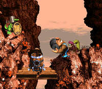 Donkey Kong Country 3: Dixie Kong's Double Trouble!: Kiddy Kong holding a Steel Barrel at a Koin at the end of Rocket Rush