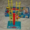 A ladder-climbing game with artwork from Super Mario Bros. The box comes with a paper Mario and Luigi suspended on a yellow ladder with a blue base. The objective of the game is to flip the ladders until the paper Mario or Luigi reaches the top.