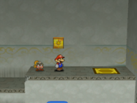 Mario next to the Shine Sprite in the warp area of Rogueport Sewers in Paper Mario: The Thousand-Year Door.