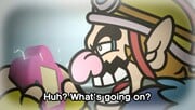 Wario checking the game console