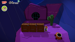 Mario standing near three crates with the middle one containing a Shiny Fire Flower in Scorching Sandpapaper Desert of The Origami King.