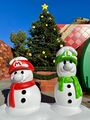 A Christmas tree and Mario and Luigi snowmen at the entrance during the holiday season