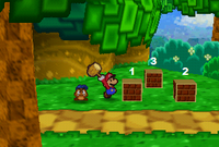 Mario and Goombario, smashing the bricks that reveal the Attack FX B badge in the game Paper Mario.