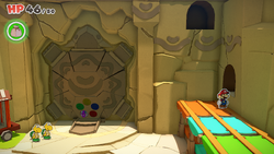 Mario standing near a Coin hidden in the opening in the wall in Picnic Road of The Origami King.