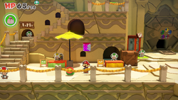Mario standing near a Fire Flower in Picnic Road of The Origami King.