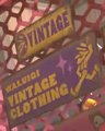 Two signs: the standard logo underneath another, more simplified logo that simply says "Vintage"