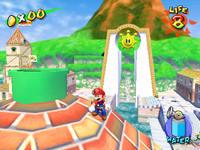 Mario stands next to an early version of Sirena Beach's pipe entrance (which is green rather than red.)