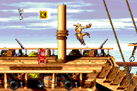 Diddy Kong standing beneath the letter K of Gangplank Galley in the Game Boy Advance version
