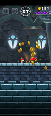 Coins spilling  out of a treasure chest in Super Mario Run, after completing a castle course