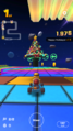Lakitu receiving a "Happy Holidays!" point bonus after hitting a festive tree with a Green Shell in SNES Rainbow Road R/T