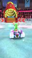 Yoshi (Reindeer) approaching the red circus cannon on Vancouver Velocity 2 in Mario Kart Tour