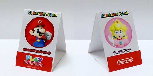 Photograph of two printed out Mario mood signs featuring Mario and Princess Peach