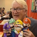 Martinet's Twitter profile picture, showing him with plushies of characters he voiced