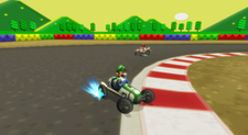 Screenshot of Luigi racing on SNES Mario Circuit 3 in his Classic Dragster from Mario Kart Wii.