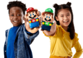 Two children holding the Mario and Luigi figures