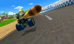 Koopa Troopa racing on the course with a Super Leaf behind his kart