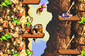 The Kongs jump to a platform with a Sneek in the Game Boy Advance version