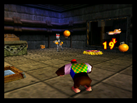 Chunky Kong throws an orange at a Robokremling in Donkey Kong 64