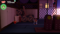 Mario standing near a Healing Heart in Big Sho' Theater of The Origami King.