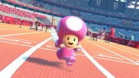 Toadette competes in the 110m Hurdles event with Shadow, Daisy, Metal Sonic, and Waluigi seen from behind.