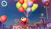 Shy Guy floating upward with a cluster of balloons for his Balloon Assist