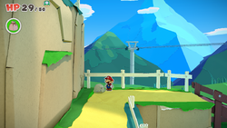 Mario standing near a rock containing a Small Bag of Confetti in Overlook Mountain of The Origami King.
