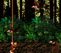 Donkey Kong climbs between Neckies in Forest Frenzy in Donkey Kong Country. The Blast Barrel leading to the first Bonus Level is hidden below.