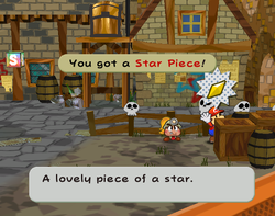 Screenshot of Mario collecting the Star Piece behind a crate in the east of Rogueport Square, from Paper Mario: The Thousand-Year Door.