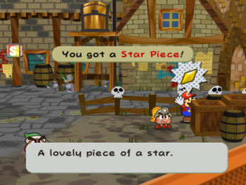 Screenshot of Mario collecting the Star Piece behind a crate in the east of Rogueport Square, from Paper Mario: The Thousand-Year Door.