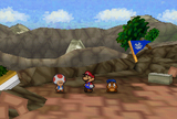 Mario, Goombario and Muss T. in front of the remains of Peach's Castle