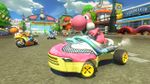 Many different colored Yoshis racing through the town section of the course
