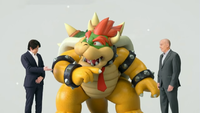 A screenshot from the E3 2019: Nintendo Direct presentation, depicting a confused Bowser questioning Yoshiaki Koizumi how Nintendo of America president, Doug Bowser, is the "right Bowser".