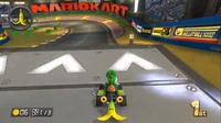 Yoshi prepares to jump a ramp on Mario Kart Stadium in Mario Kart 8.
