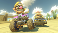 Wario racing on Dry Dry Desert, with Bowser close behind.