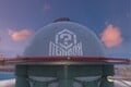 The logo on the Toad's Factory building in Mario Kart World