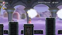 A screenshot from Ludwig's Clockwork Castle in New Super Mario Bros. U Deluxe, featuring two Bony Beetles. One is retracted into its shell, the other is not.
